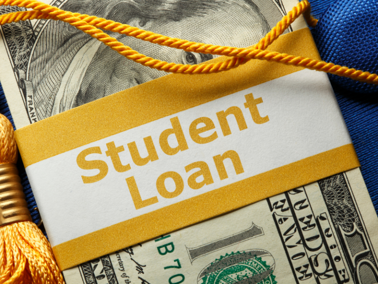 Close-up of a one-dollar bill with a yellow and white label reading "Student Loan" and a graduation tassel.