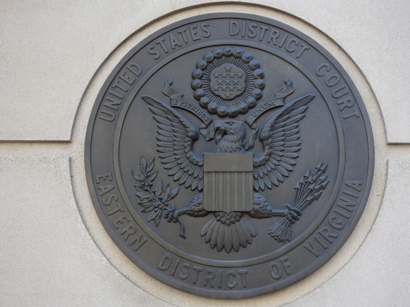 Bronze seal of the United States District Court for the Eastern District of Virginia mounted on a beige stone wall.