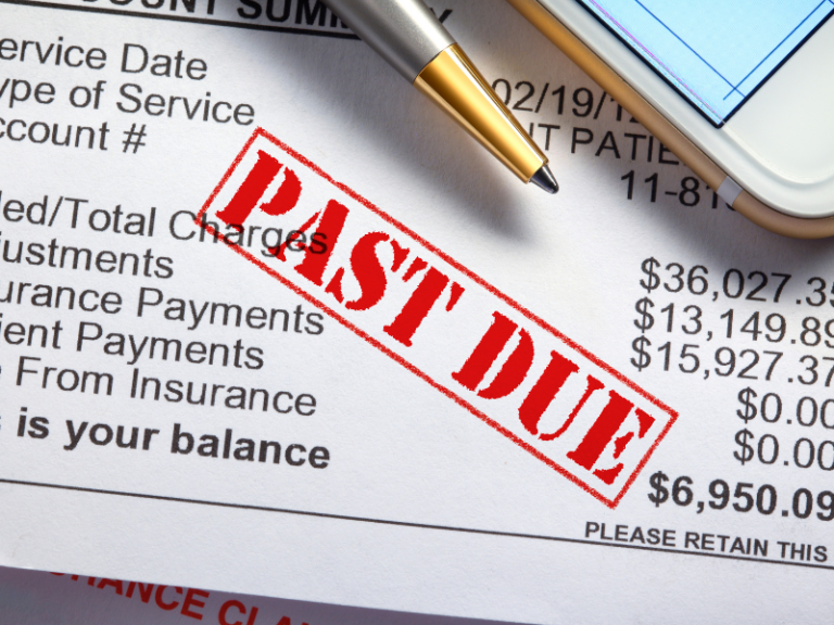 Close-up of a financial document stamped "PAST DUE" in red, with a pen and smartphone nearby.