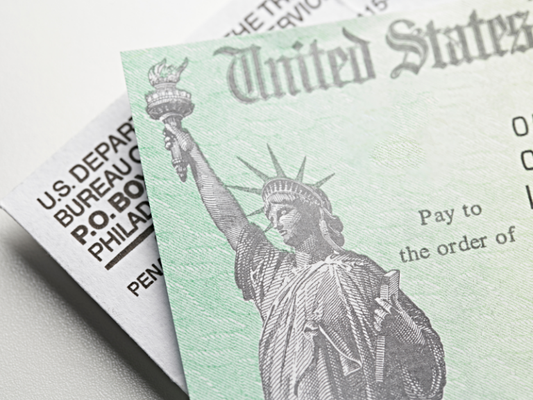 Close-up of a United States Treasury check featuring the Statue of Liberty illustration.