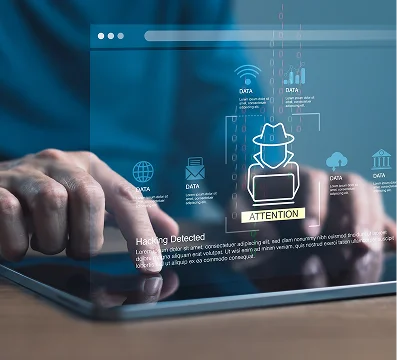 Person using a tablet with holographic cybersecurity warning and data icons displayed.