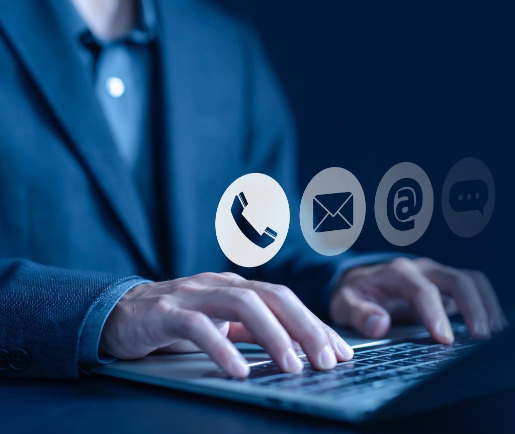 closeup of typing hands with icons floating for illustrative purposes