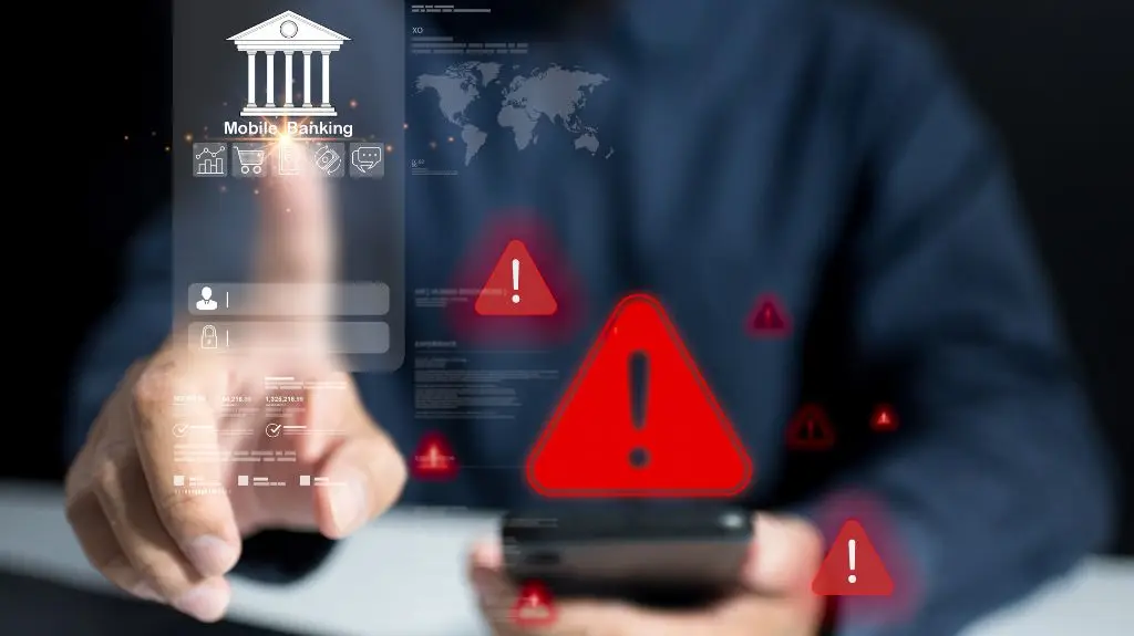 Person using smartphone with digital mobile banking interface and red warning icons.